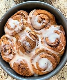 Tight shot of glazed pan of cinnamon rolls