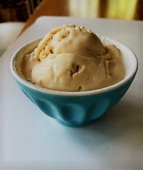 blue ribbed dish containing scoop of peanut butter frozen yogurt