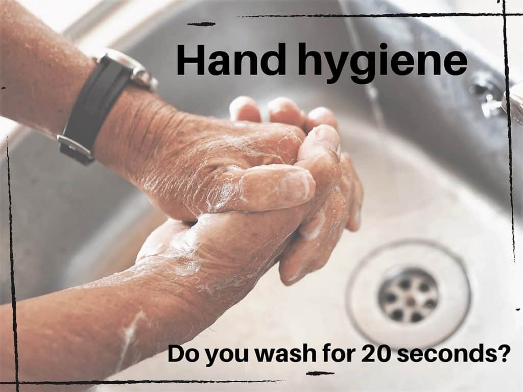 soaped hands rubbing together in a sink