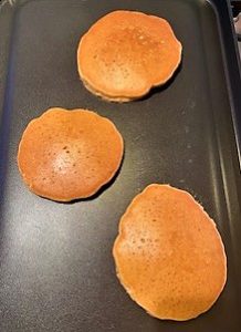 Golden brown pancakes after flipping