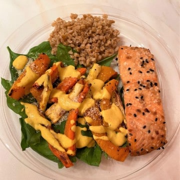 roasted salmon fillet on bed of spinach with roasted root veggies and farro