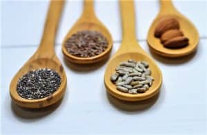 Wooden spoons holding seeds and nuts, important elements of the Mediterranean Diet