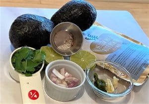 Avocados, maca powder, cilantro and other ingredients for Macamole