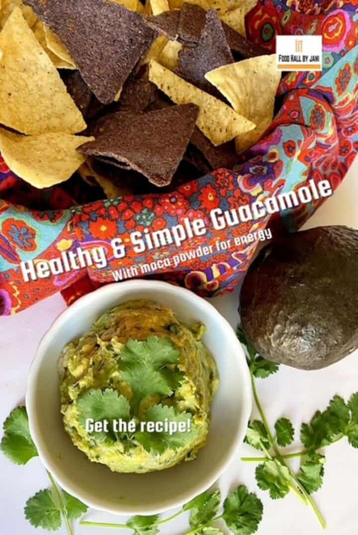 Basket of blue and yellow tortilla chips above a small white bowl filled with a scoop of green guacamole dip.