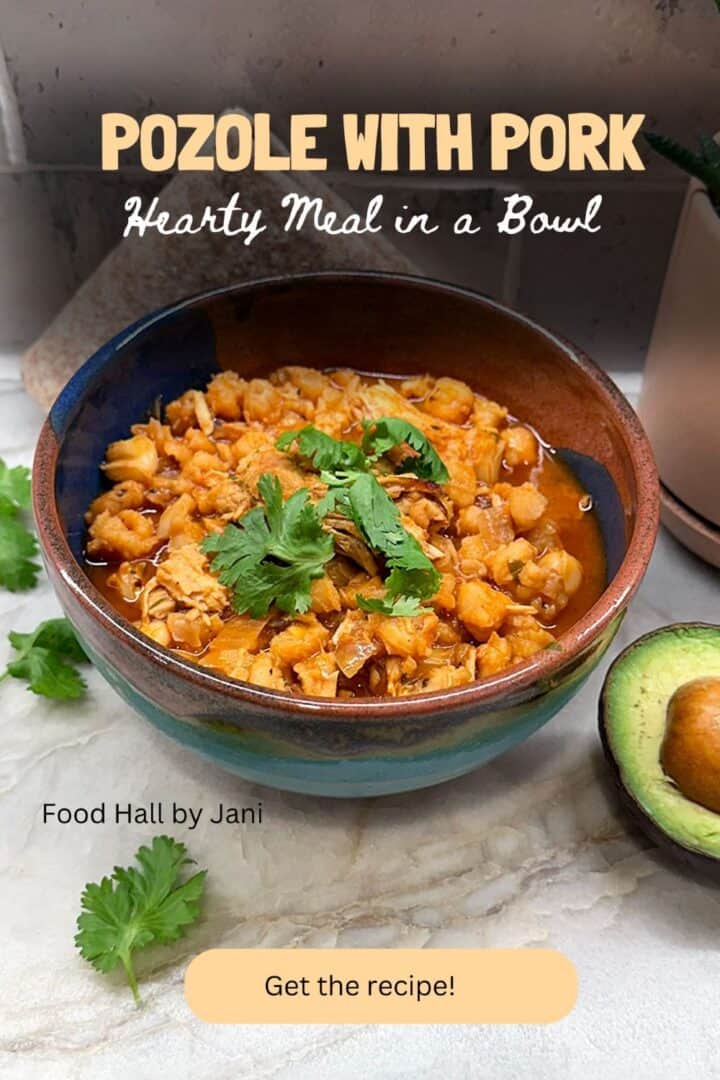 Colorful rustic bowl holds a pozole stew full of hominy corn and garnished with cilantro.