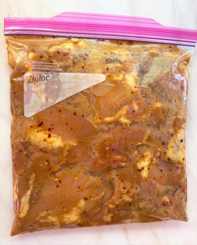 Zip bag with boneless chicken thighs in marinade