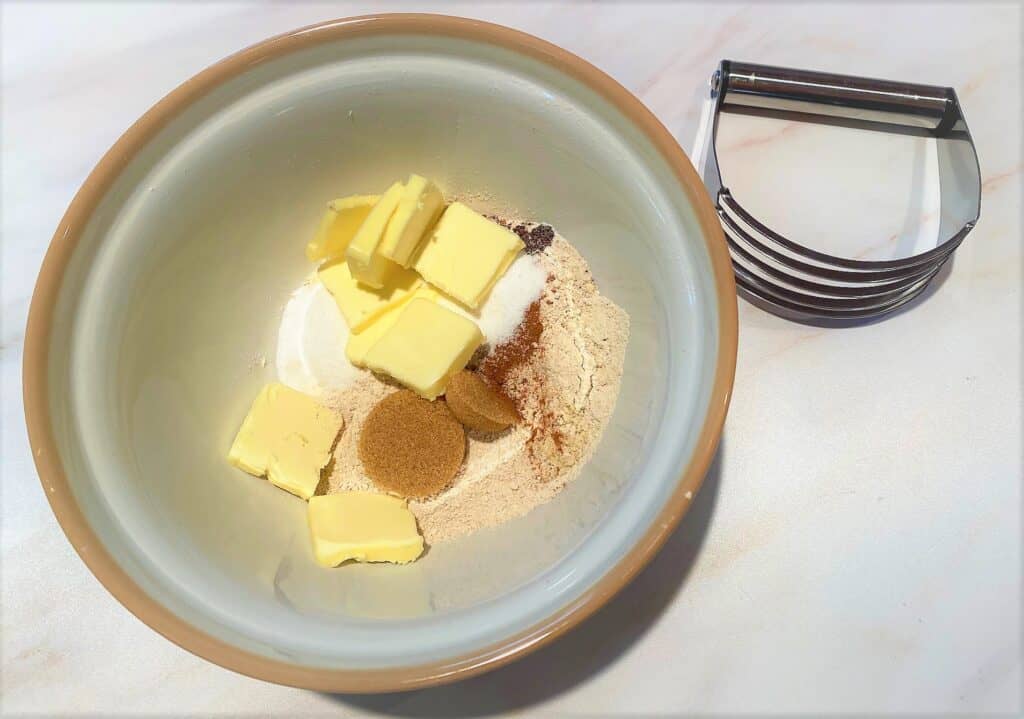 Dry ingredients for apricot crumble with butter and pastry cutter