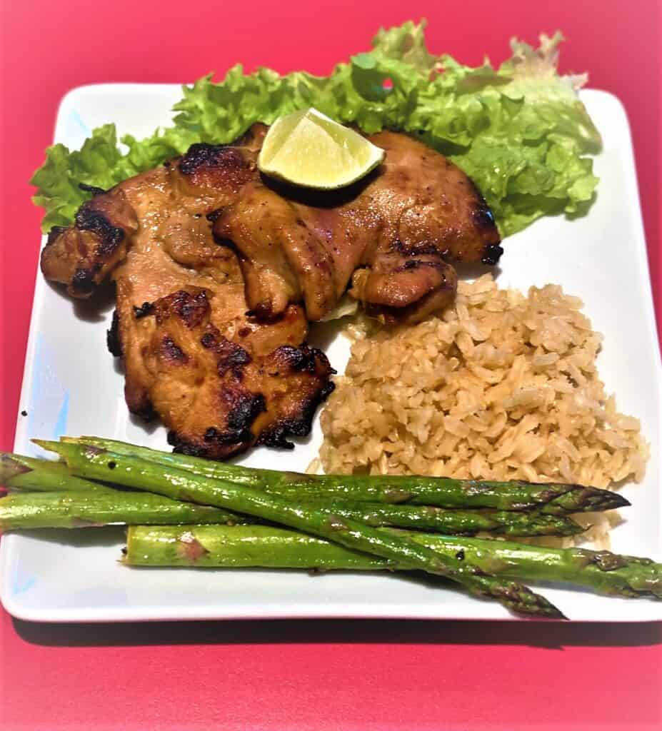 Grilled boneless chicken thighs with rice and asparagus