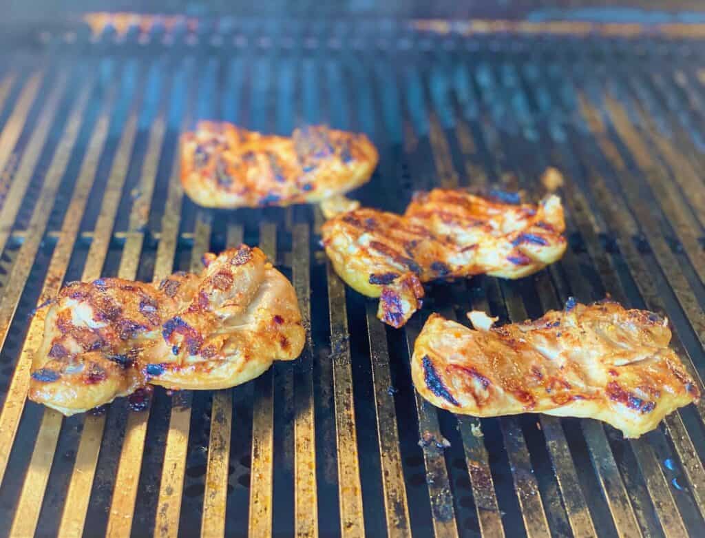 boneless skinless chicken thighs on grill with marks