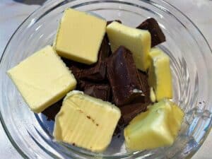 bowl of butter chunks and chocolate chunks to melt for carb-conscious erythritol brownies