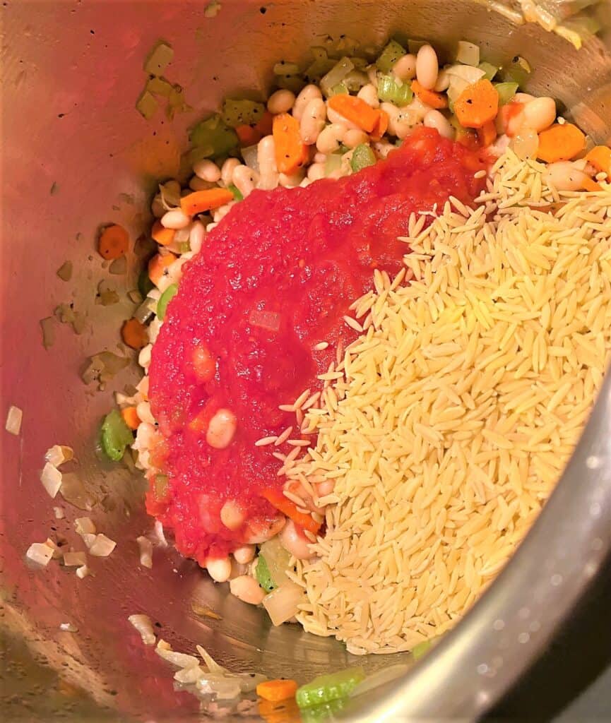 Minestrone di Verdure adding orzo, tomatoes, and beans