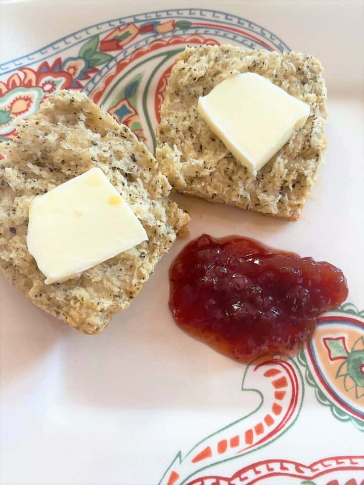 Earl Grey scone with butter pats and preserves on paisley plate