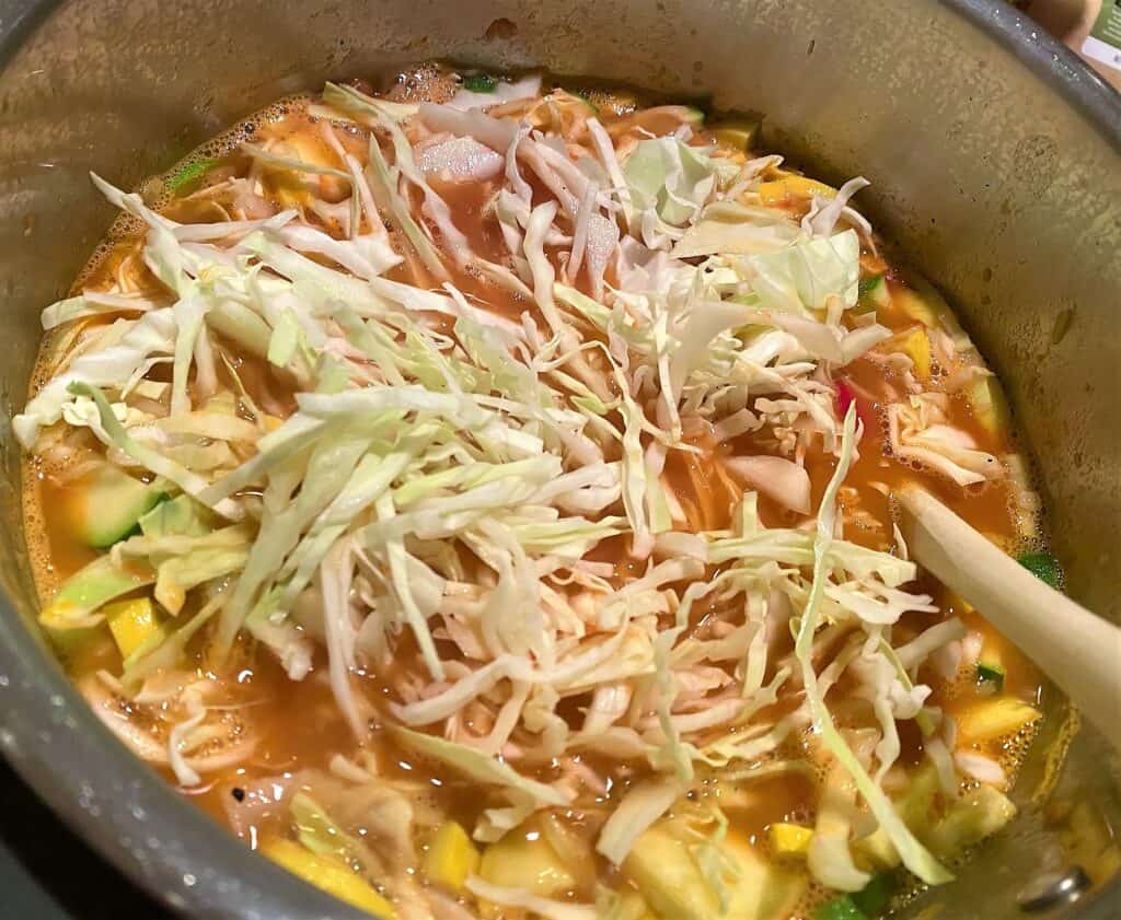 Adding cabbage shreds, zucchini, squash to Minestrone di Verdure in the Instant Pot