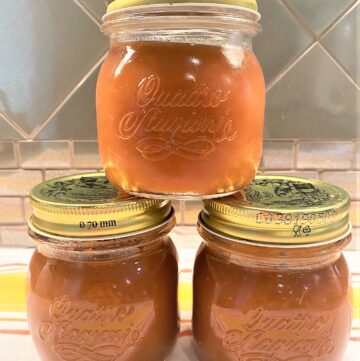 Three jars of apple butter stacked in a pyramid