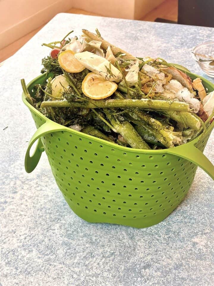 Instant Pot green silicone steamer basket full of frozen veggie scraps