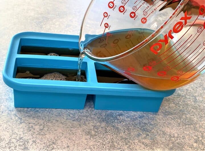 Pouring veggie scraps broth into a Souper Cube storage