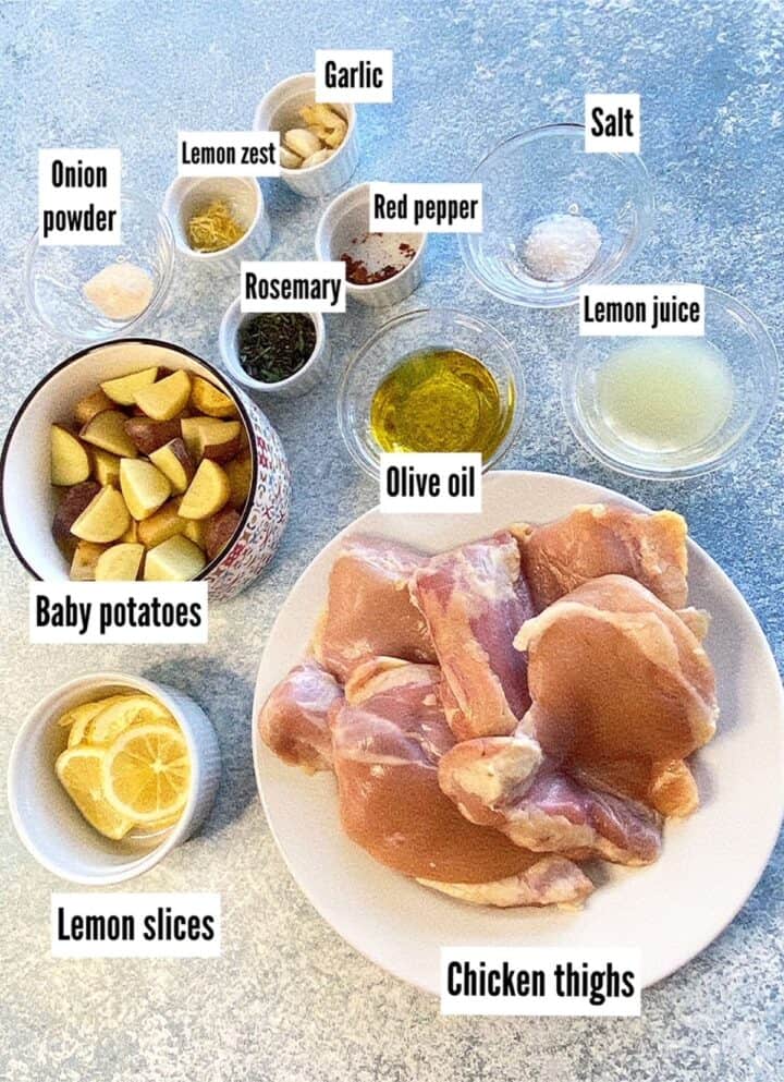 Ingredients necessary for Lemon Chicken Tray Bake weeknight oven dinner with labels on a blue background