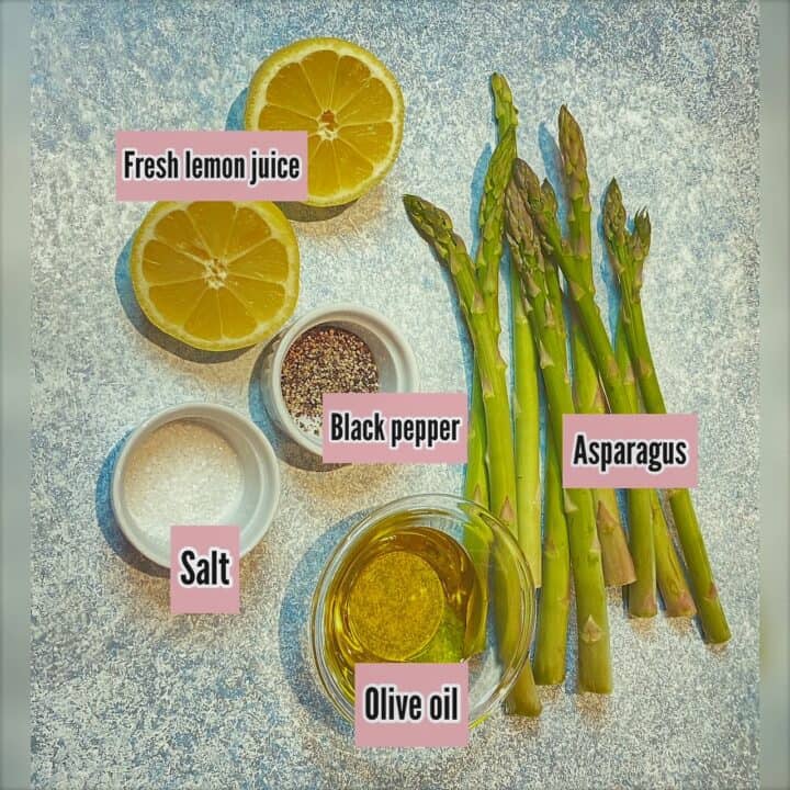 Ingredients needed for asparagus recipe including lemon halves, salt, pepper, oil, and asparagus on blue background with pink labels