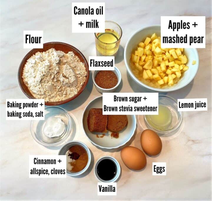 Ingredients for apple-pear bread labeled on a marble counter top