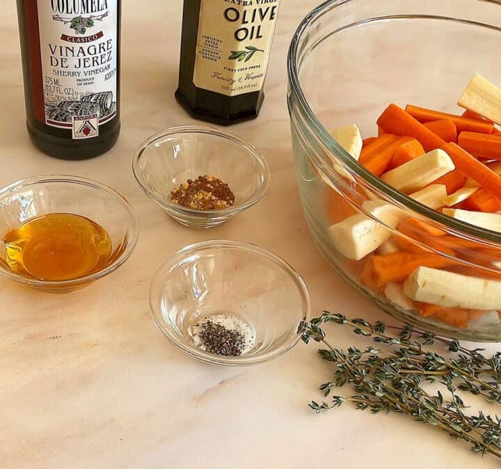 Olive oil, Sherry vinegar, spices, fresh thyme, and a clear bowl with carrot and parsnip logs
