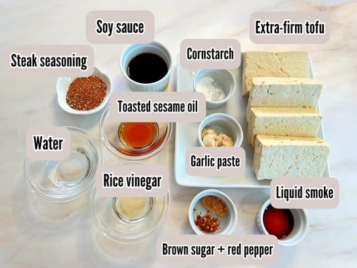 Tofu cut into slabs plus soy sauce and other marinade ingredients including steak seasoning.