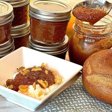 Small jars of caramel colored pear butter, plus the thick brownish butter on a spoon and topping plain yogurt in a white dish.