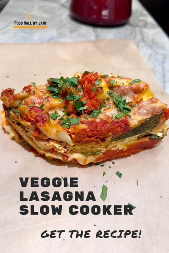 A single piece of Vegetable Lasagna showing the layers with red splotches of tomato sauce.