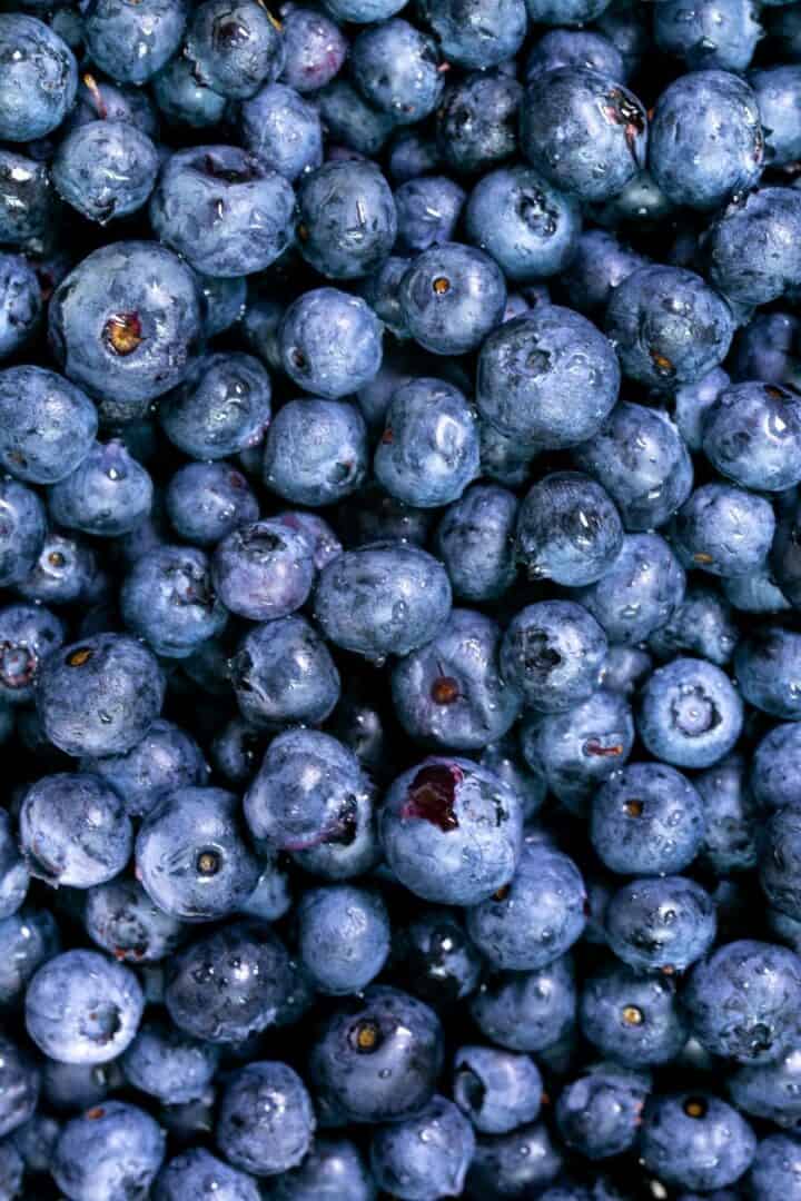 Narrow photo closeup of blue blueberries.