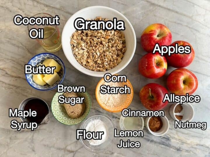 Granola, red apples, brown sugar, and other ingredients for apple crisp.