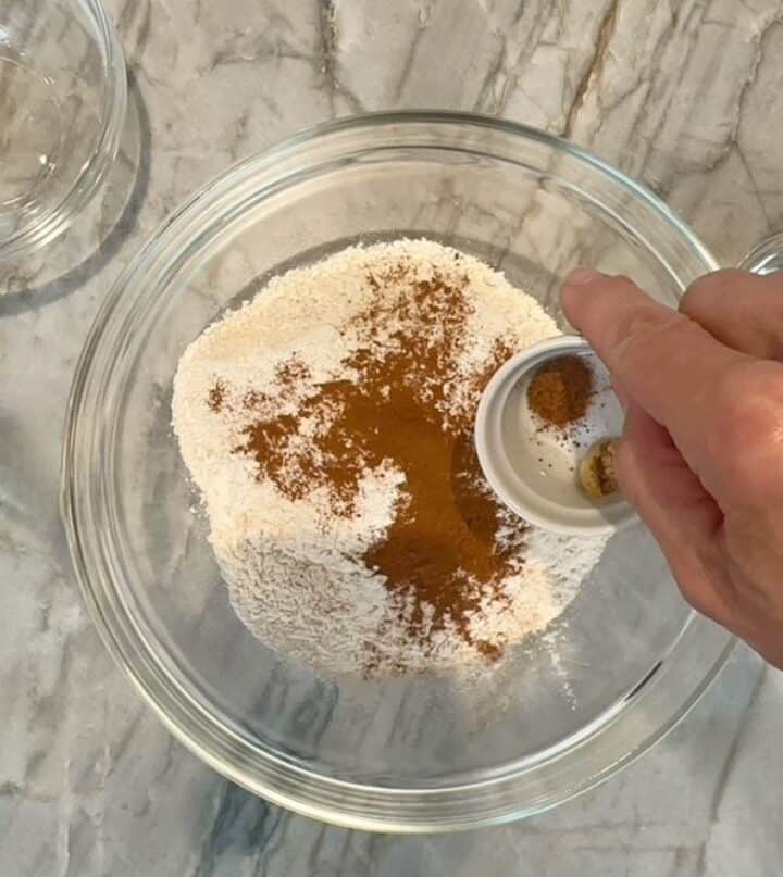Clear bowl with light flours and brownish spices.