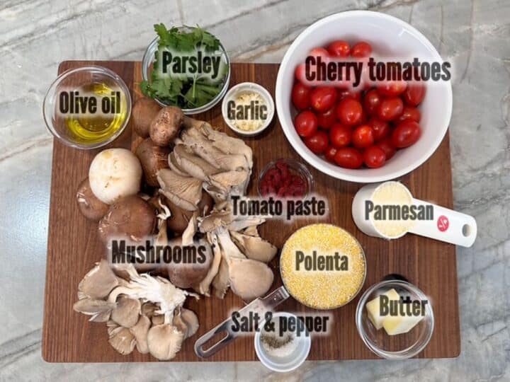 Ingredients for baked polenta with mushrooms and cherry tomatoes including red tomatoes, yellow cornmeal, butter, green Italian parsley, and brown mushrooms.