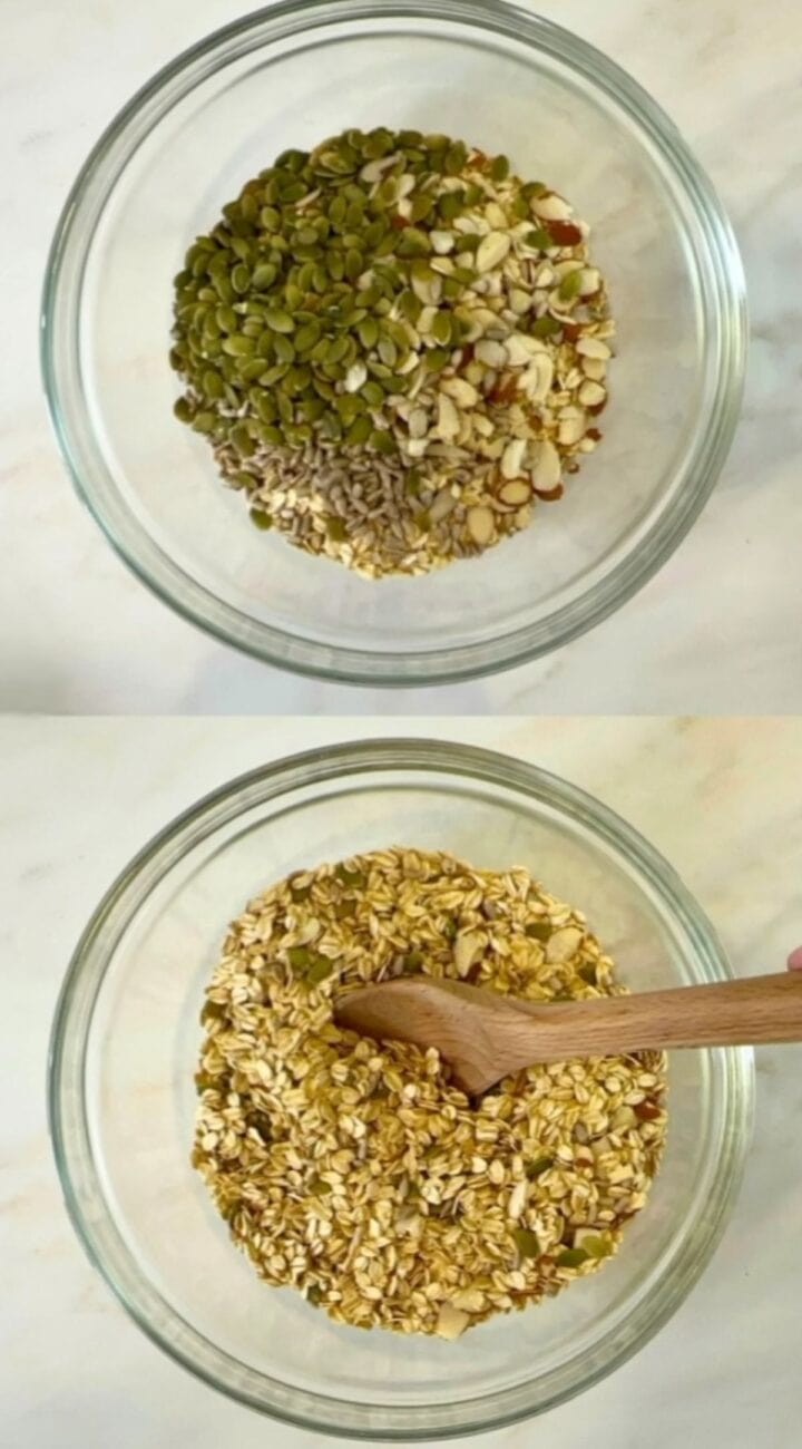 Pumpkin and sunflowers seeds plus almonds atop rolled oats in a large clear bowl.