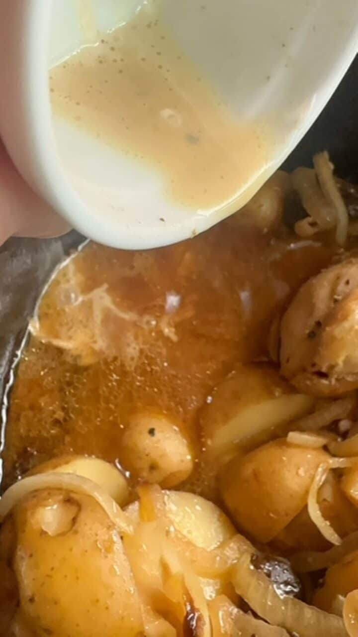 An off-white mix of cornstarch and slow cooker juices is poured back into slow cooker.