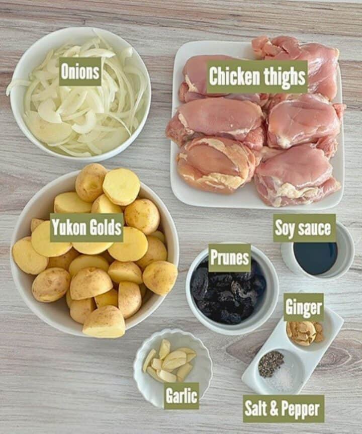 Pink raw chicken thighs, yellow gold potatoes, prunes and more for a slow-cooker meal.