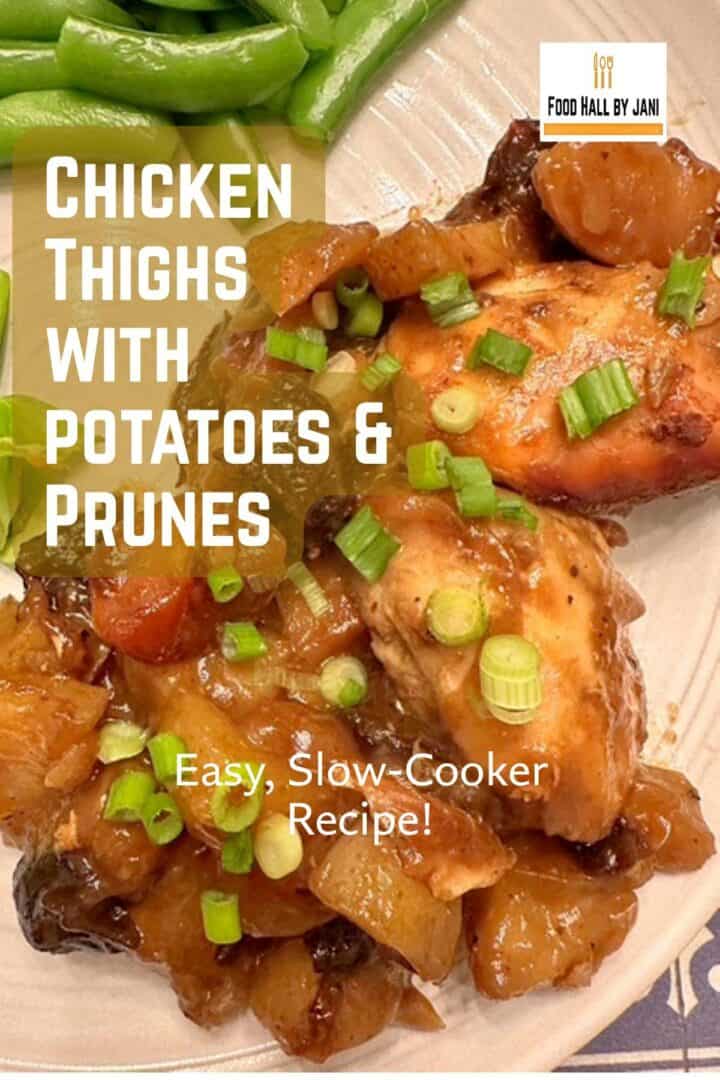 Close-up of slow-cooked chicken thighs surrounded by baby potatoes and dark prunes in a caramelized sauce topped with green onions.