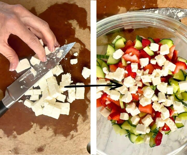Cutting feta into cubes on brown board and adding cubes to bowl with watermelon strawberry cucumber salad.
