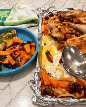 Chicken legs with roasted sweet potatoes and vegetables on a baking sheet and plate.